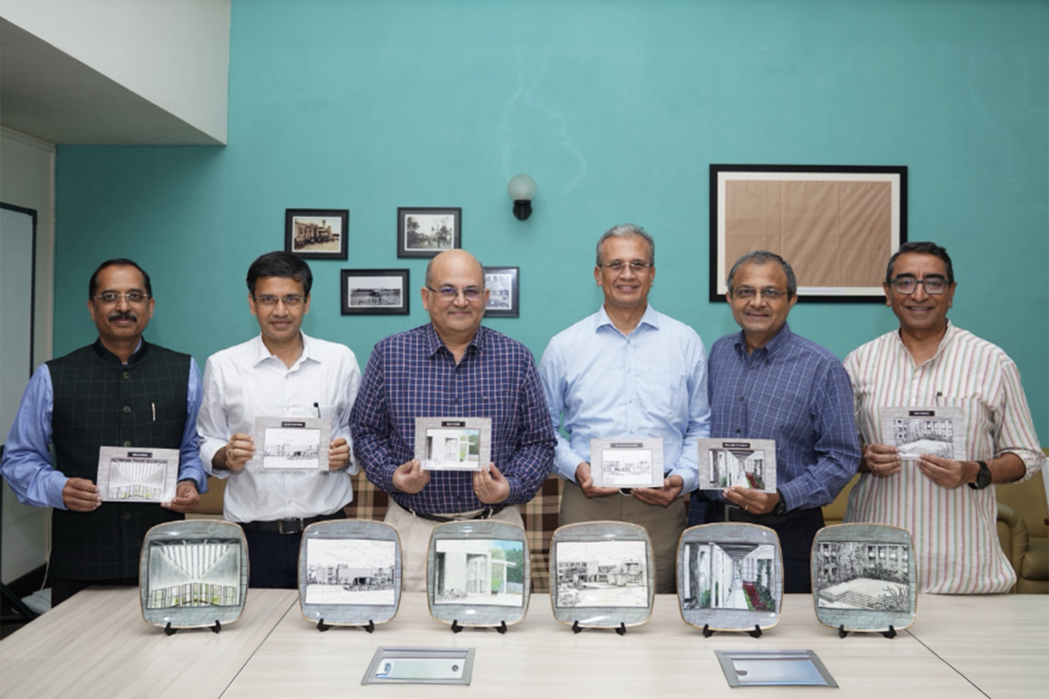 (L-R) IIMB alumni Sundaresan A S, CEO – JSW Paints; Srikanth Nott, Director, Cowrie Capital; and Subramanian R S, SVP, South Asia, DHL Express, gifted photographs of the campus etched on ceramic plates to the IIMB Director, Prof. Rishikesha T Krishnan, Dean of Alumni Relations & Development Prof. Sourav Mukherji and Prof. G Shainesh, at IIMB, on 16th October 2024.